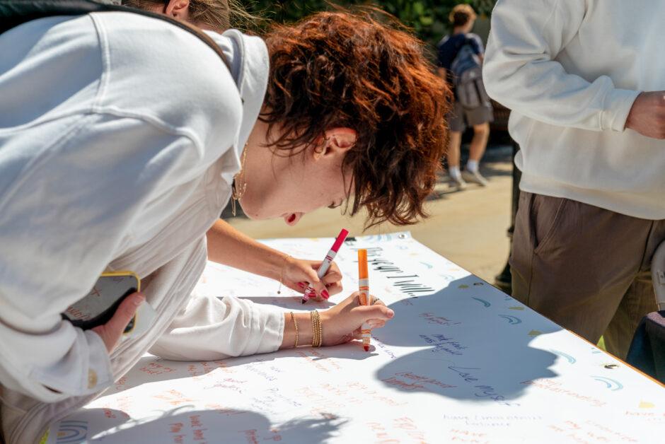 Students write their ambitions for the year on the O’Neill Plaza during the annual Wellfest event on Wednesday, September 20, 2023 (Shane Shebest / Heights Staff).