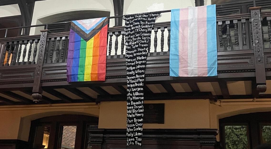 The O'Connell House grew silent as members of the Queer Leadership Council (QLC) read aloud the names of transgender people killed this year in the United States, placing flowers in front of their photos.
