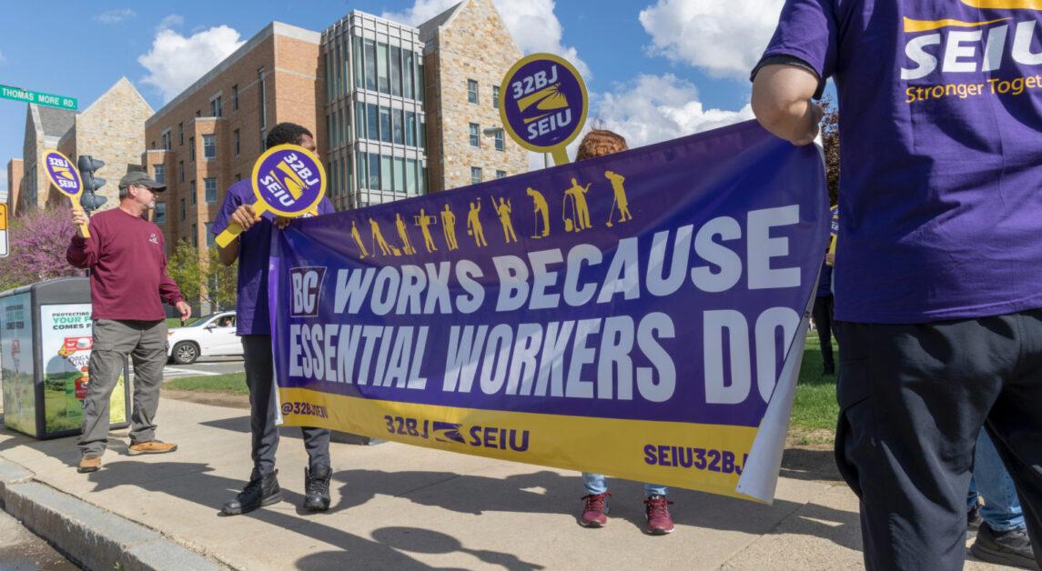 Employees, students, faculty, and community members gathered across from St. Ignatius Church Wednesday afternoon to call on Boston College to raise wages and increase training funds for facilities workers amid ongoing contract negotiations. 